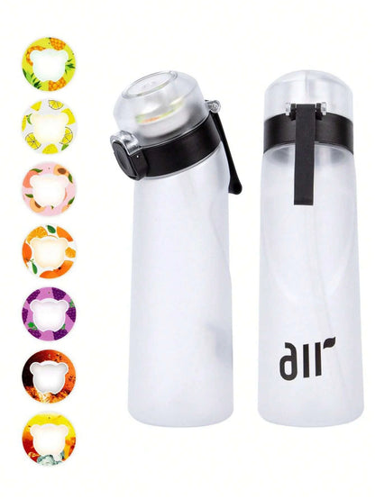 Clear water bottles with black lids and colorful band designs on a white background
